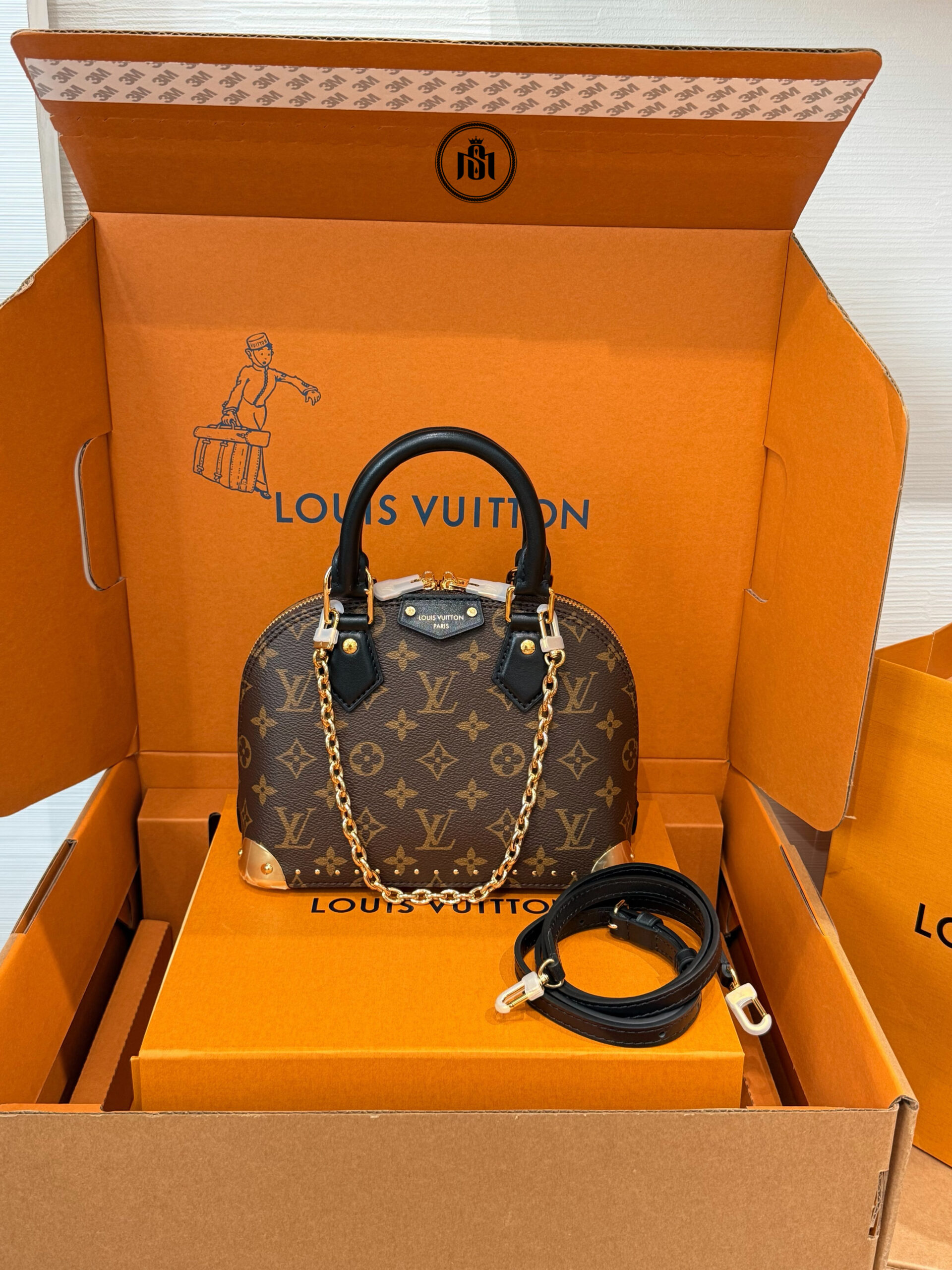 TÚI LOUIS VUITTON ALMA TRUNK BB MONOGRAM M26084 1 TÚI LOUIS VUITTON ALMA TRUNK BB MONOGRAM M26084